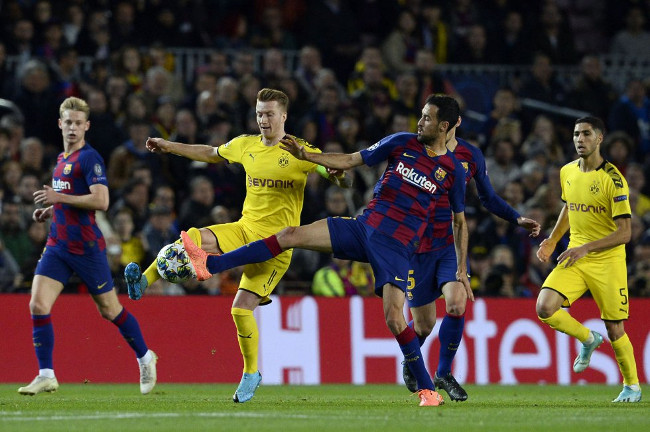 Marco Reus y Sergi Busquets disputan el balón. /Foto: Pau Barrena (AFP)