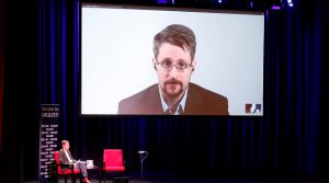 Edward Snowden participa por videoconferencia en una discusión de su libro 'Registro permanente', en Berlín (Alemania), 2019. /Foto: Fabrizio Bensch (Reuters)